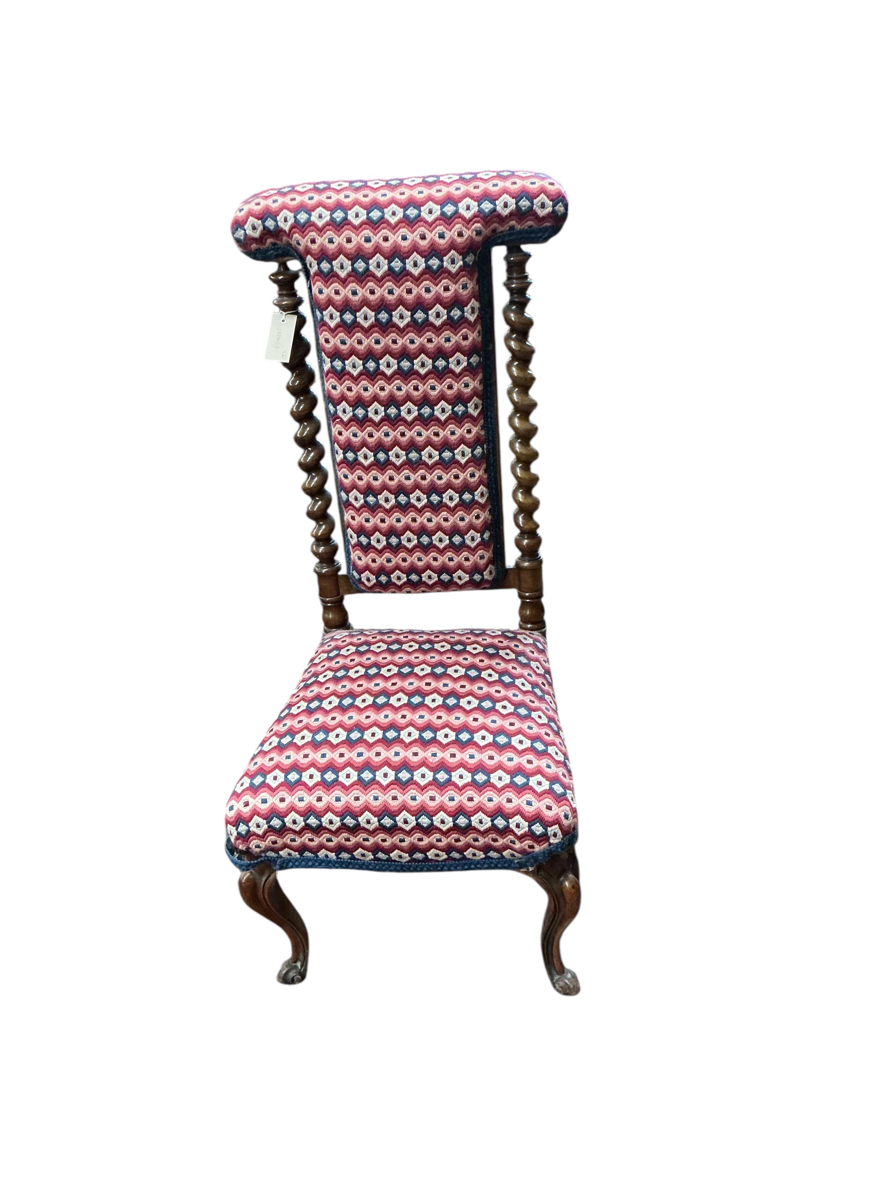 A Victorian upholstered walnut prie dieu chair, a Victorian fender stool and an Edwardian mahogany torchere